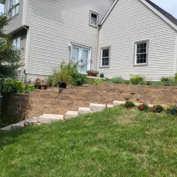 Retaining wall completed by Customer Care Lawn Service. Picture on The Local Hub Iowa City