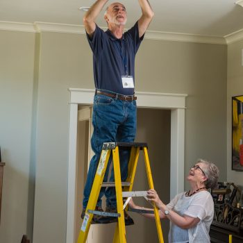 TRAIL volunteer helping a member change their light, image on The Local Hub Iowa City